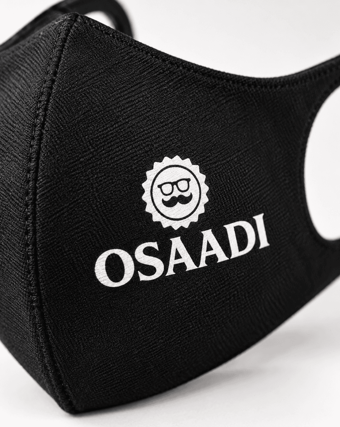 Close-up of custom name lettering printed on a black face covering.